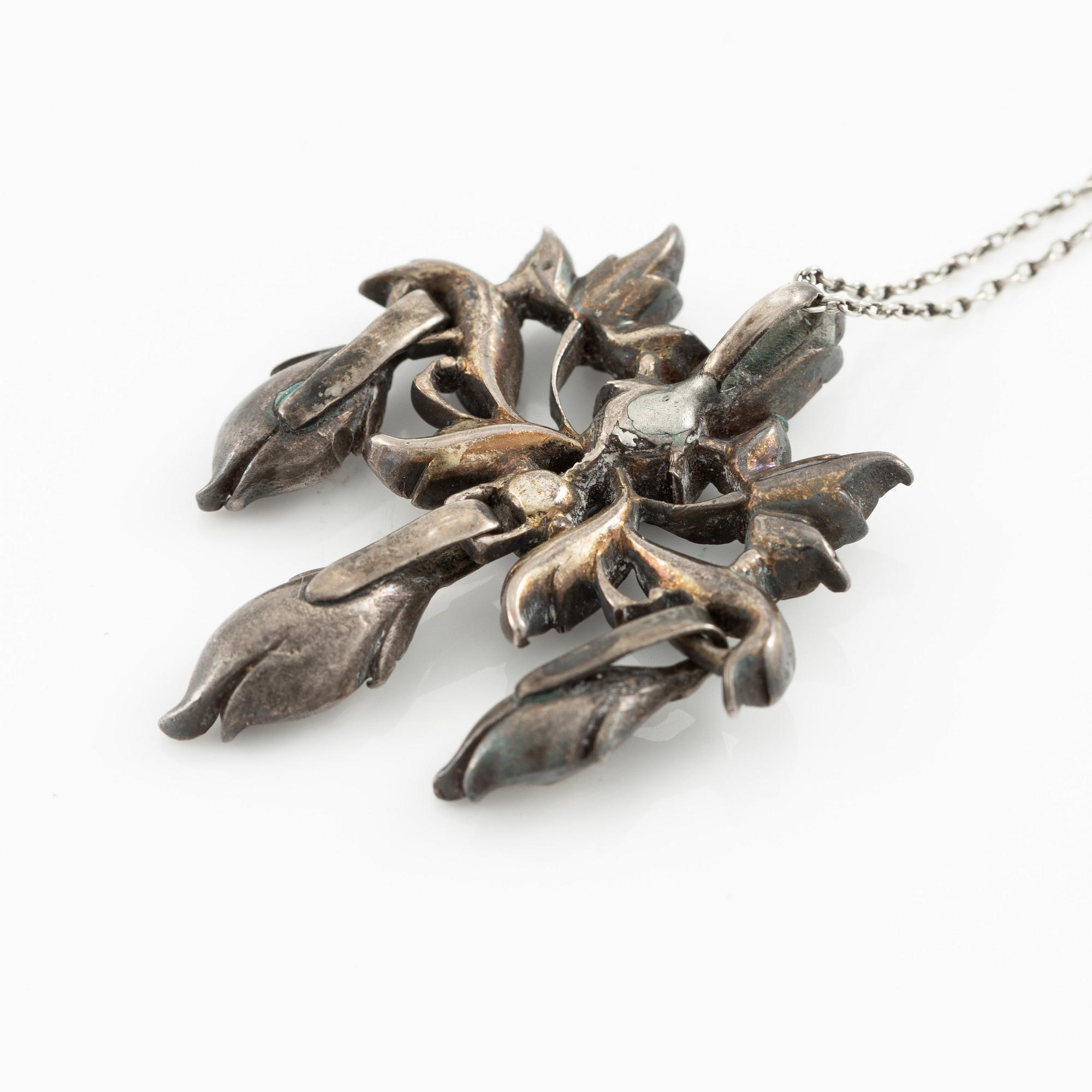 A brooch, a brooch pin, and a pendant, likely 19th century.