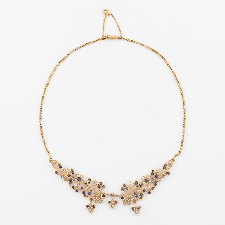 A 14K gold necklace with sapphires and pearls.