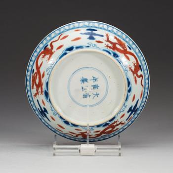 A blue and white dish with a red four clawed dragon, Qing dynasty (1644-1912), with Yongzheng six character mark.