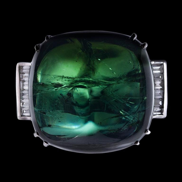 A large cabochon cut green tourmaline and baguette cut diamond ring.