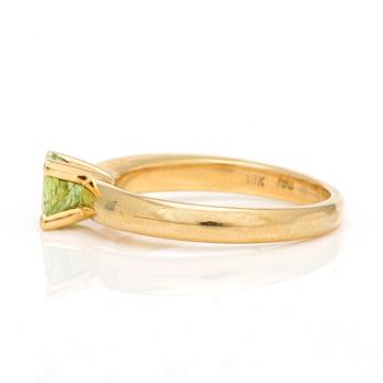 A ring with round, mixed-cut peridot.