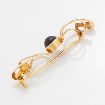 A pair of earrings and a brooch.