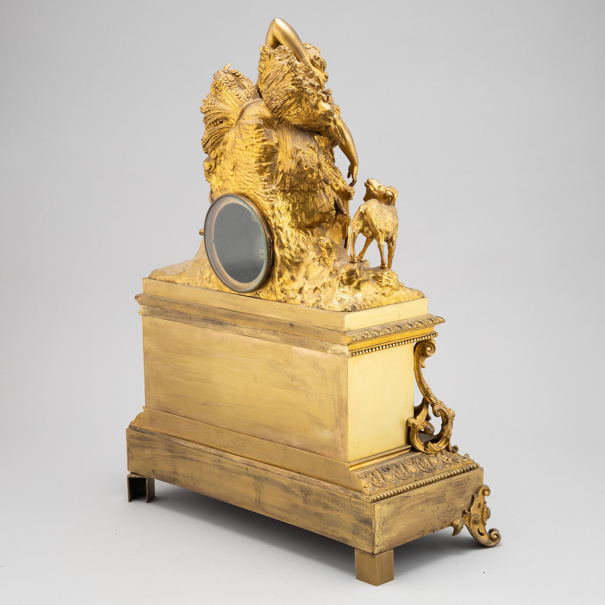 A mid 19th Century brass and gilt brass mantel clock.