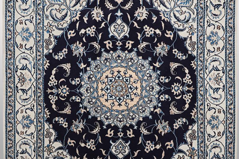 A carpet, Nain, part silk, ca 256 x 199 cm.
