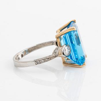 Ring, cocktail ring with large blue topaz and brilliant-cut diamonds.