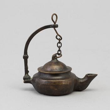 An 18th century bronze oil lamp.