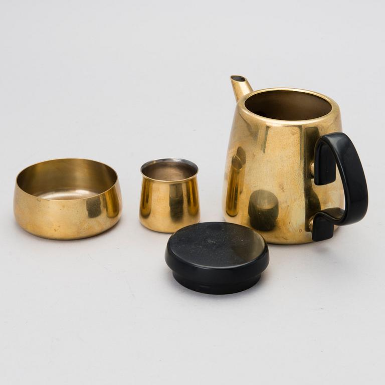 A tea/ coffee pot, a sugar bowl and a cream jug in brass for Georg Jensen, Denmark. Design year 1970.