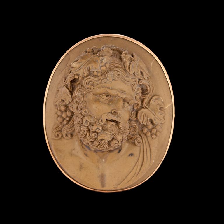 A carved lava cameo brooch. 19th century.