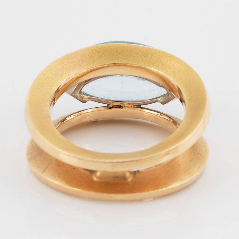 18K gold and navette shaped blue topaz.