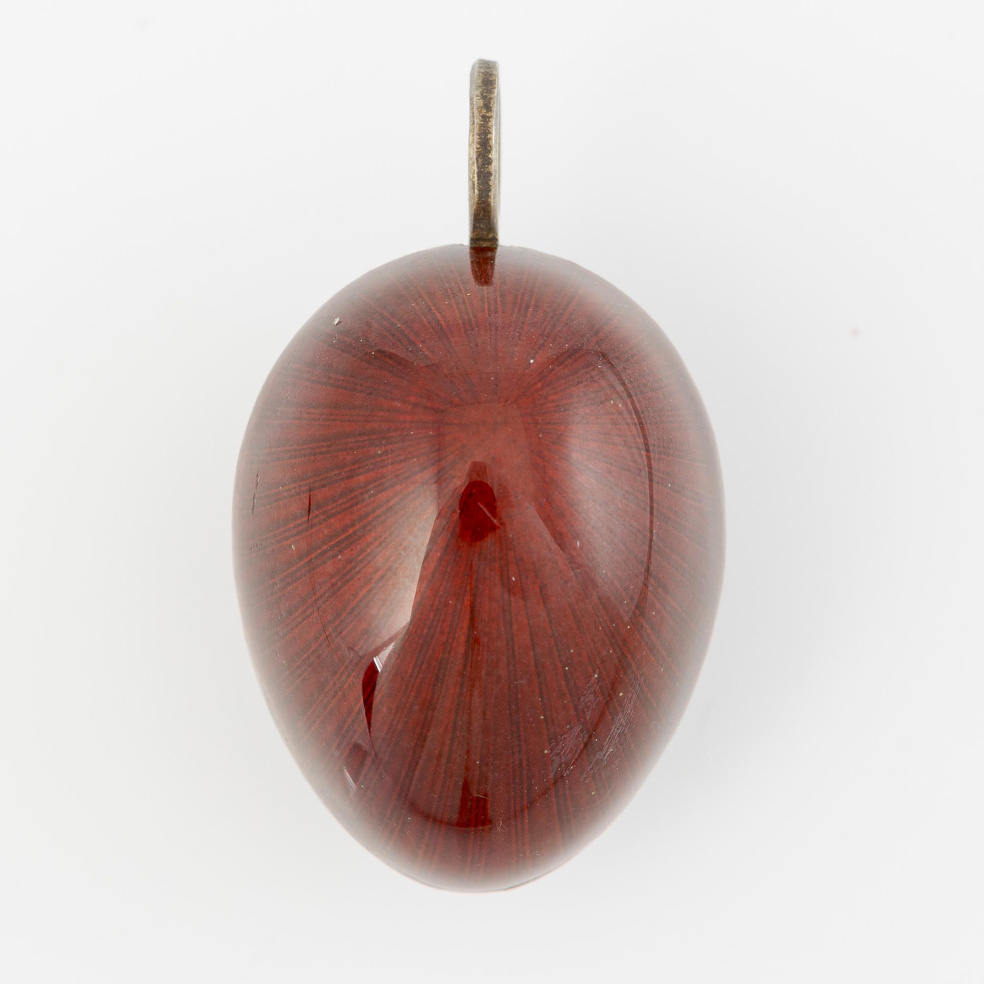 Pendant in the shape of an egg, silver with red enamel.