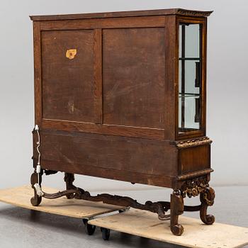 a baroque-style vitrine cabinet from the first half of the 20th century.