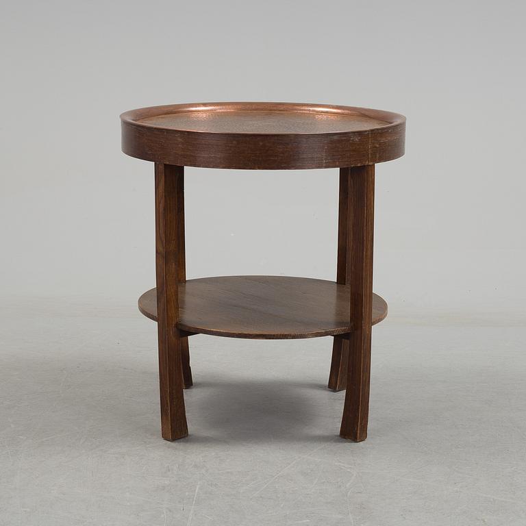 A early 20th century oak table with copper top.