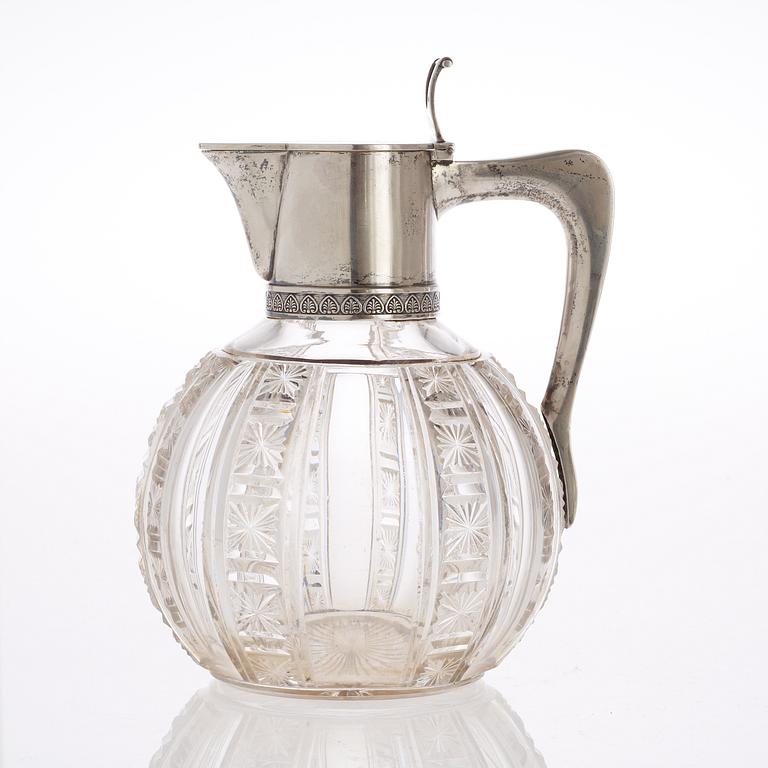 A Russian early 20th century glass and parcel-gilt jug, makers mark of the firm Morozov, (S:t Petersburg).