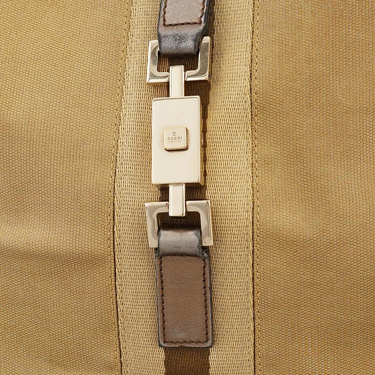 GUCCI, a metallic bag.