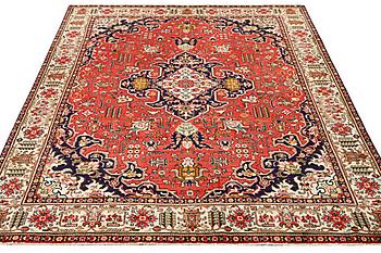 A Tabriz carpet, c. 335 x 257 cm.