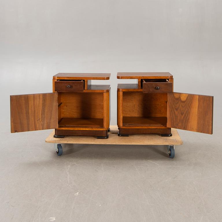 A pair of walnut/mahogany bedside tables first half of the 20th century.