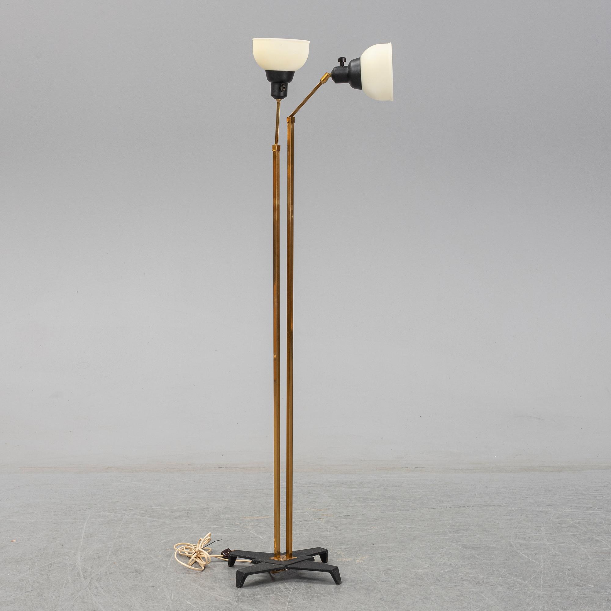 A 1950s brass and glass floor lamp.