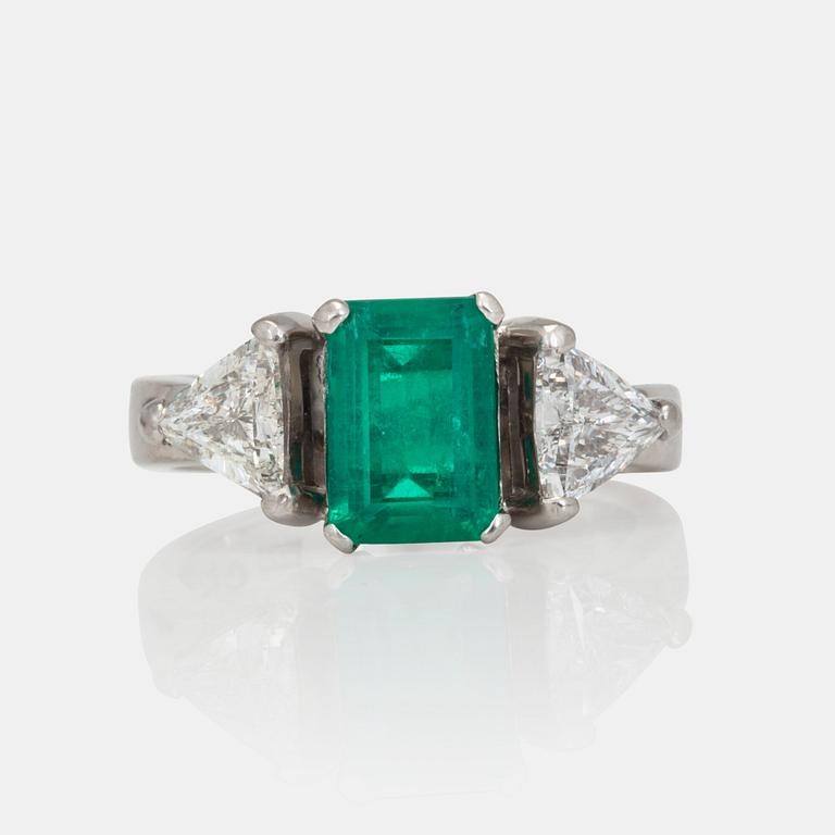 A circa 1.85ct emerald and trilliant-cut diamond ring.