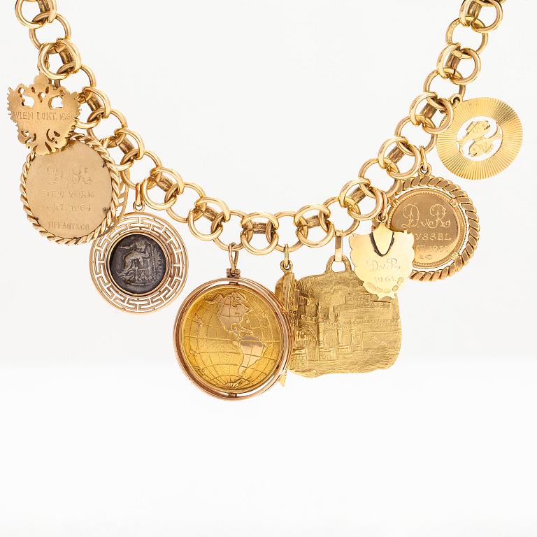 An 18K gold bracelet with large charms.