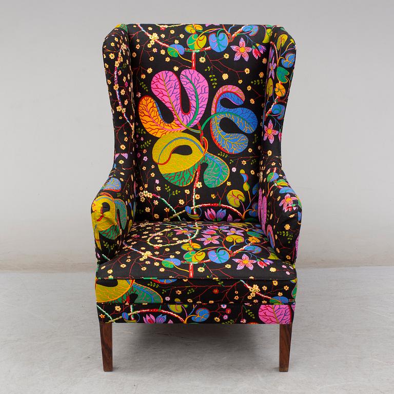 A 1960's/70's wing-chair with rosewwod legs.