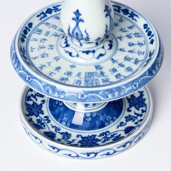 A pair of blue and white pricket candle sticks, with a poem, Qing dynasty with a Qianlong mark and of the period.