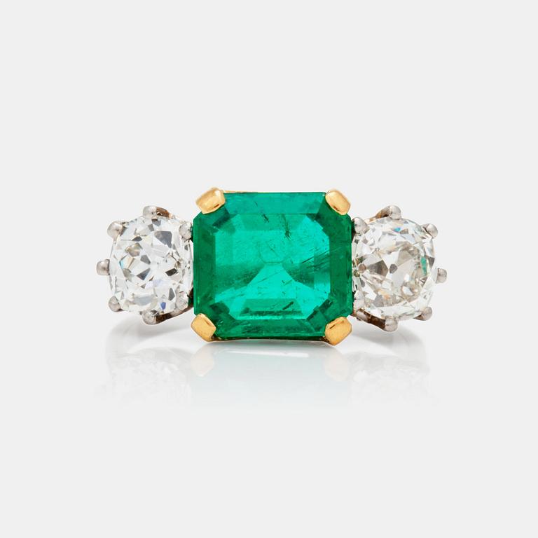 An old-cut diamond and step-cut emerald ring.