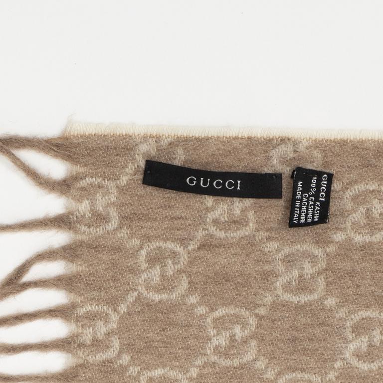 Gucci, a monogram cashmere scarf.