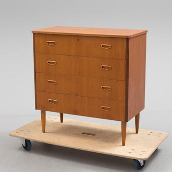 A second half of the 20th century teak veneered chest of four drawers.