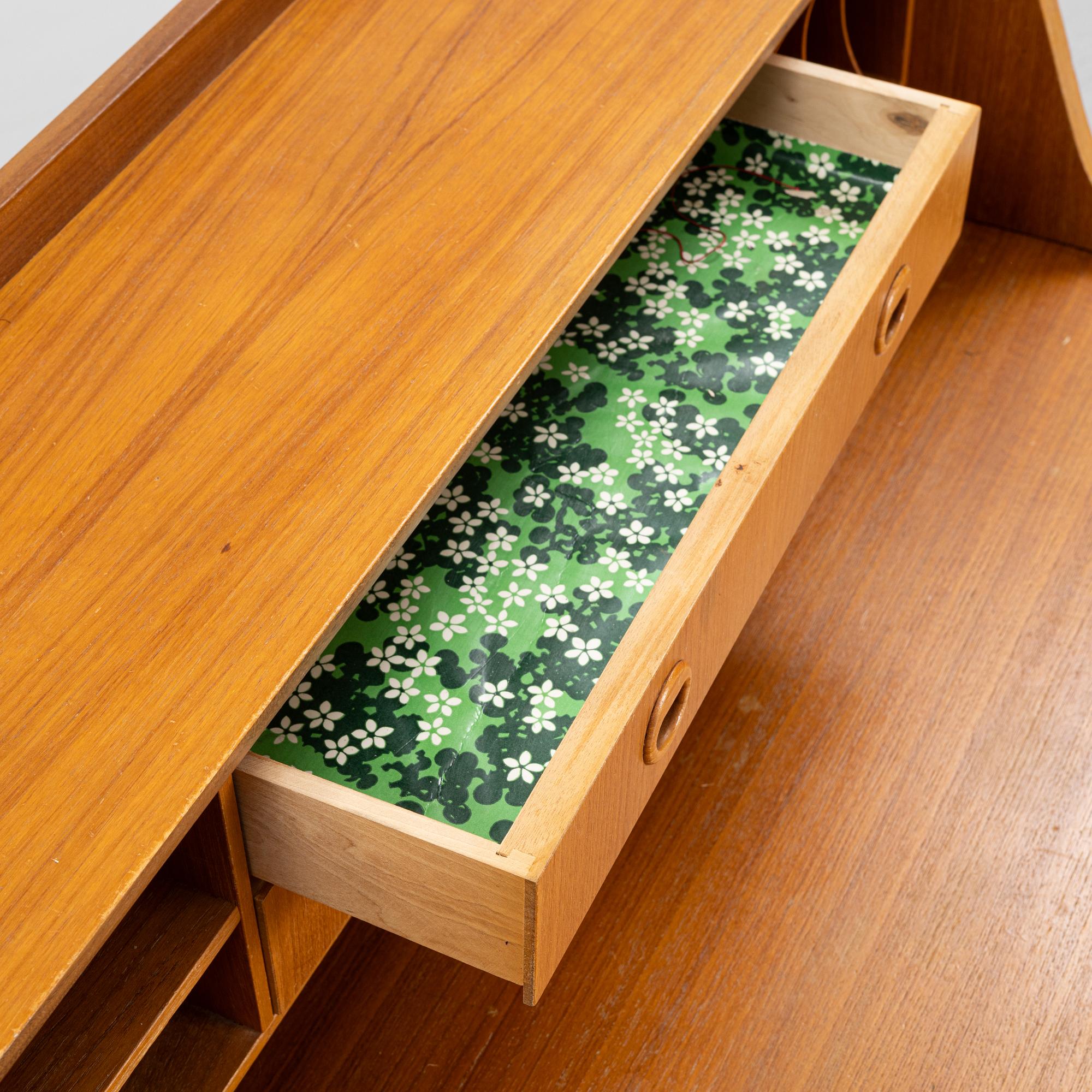 A teak-veneered desk, mid 20th century.