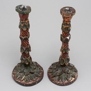 A pair of wooden candle sticks, first half of the 19th century.
