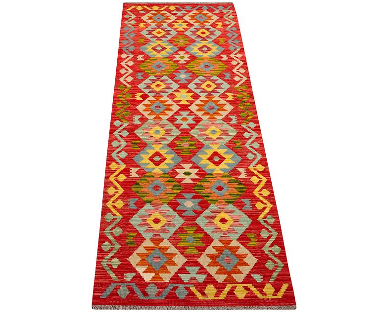 An Afghan kilim runner, c. 301 x 83 cm.