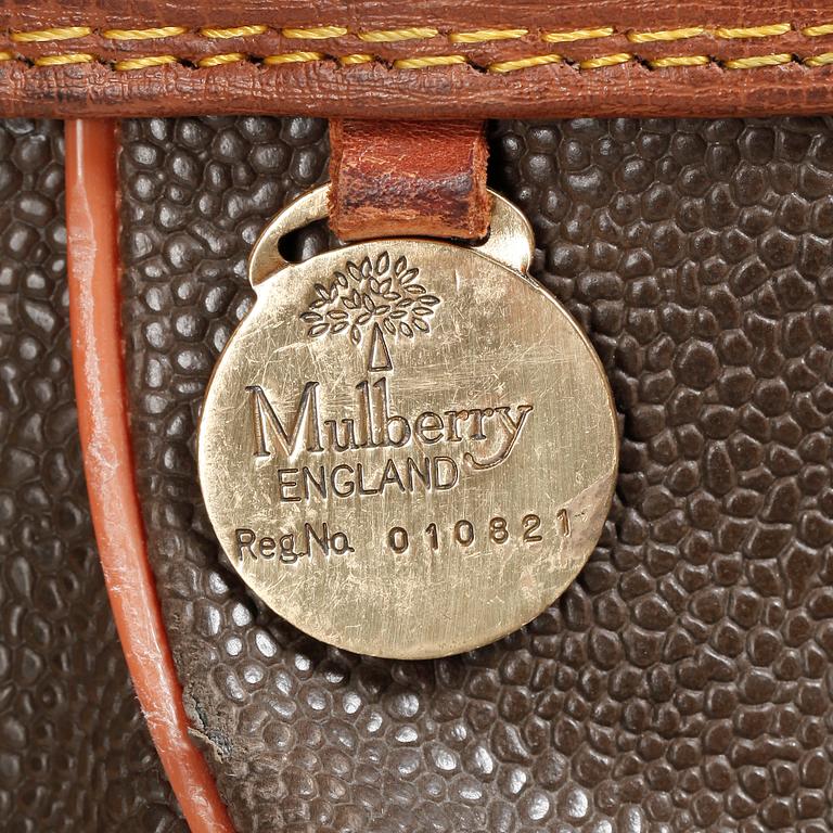 MULBERRY, a green leather golf bag with golf clubs.