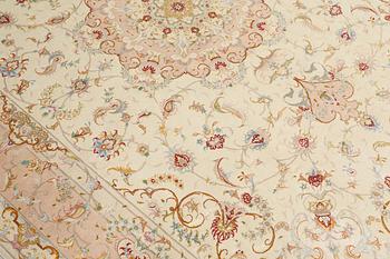 A Tabriz part silk carpet, signed, 305 x 203 cm.
