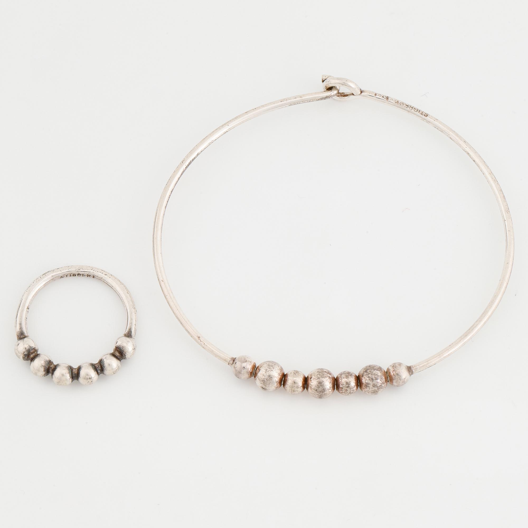 A silver bracelet and ring Stigbert.