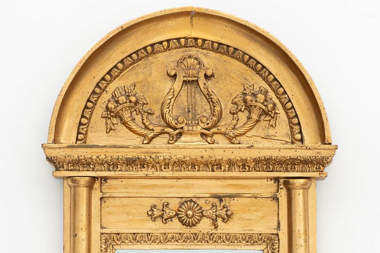 An Empire mirror, early 19th Century.