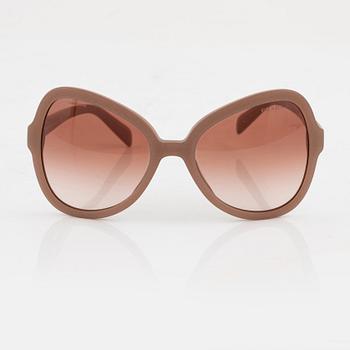 Prada, a pair of coral pink color sunglasses.