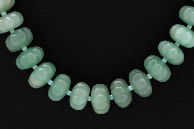 Necklace carved jade beads approx 15 mm and smaller glass beads , clasp metal, approx 50 cm.
