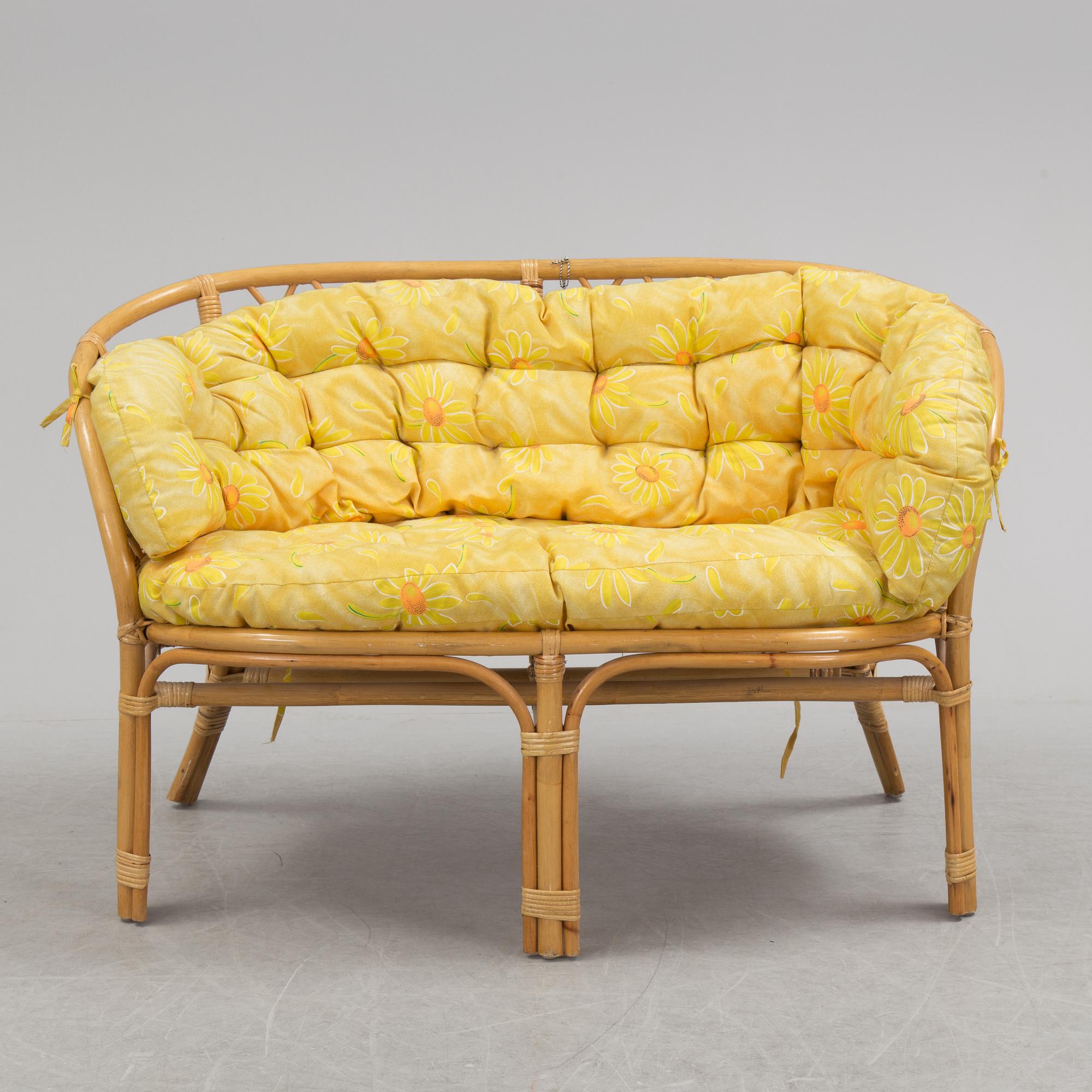 A 1970s four piece set of rattan garden furniture.