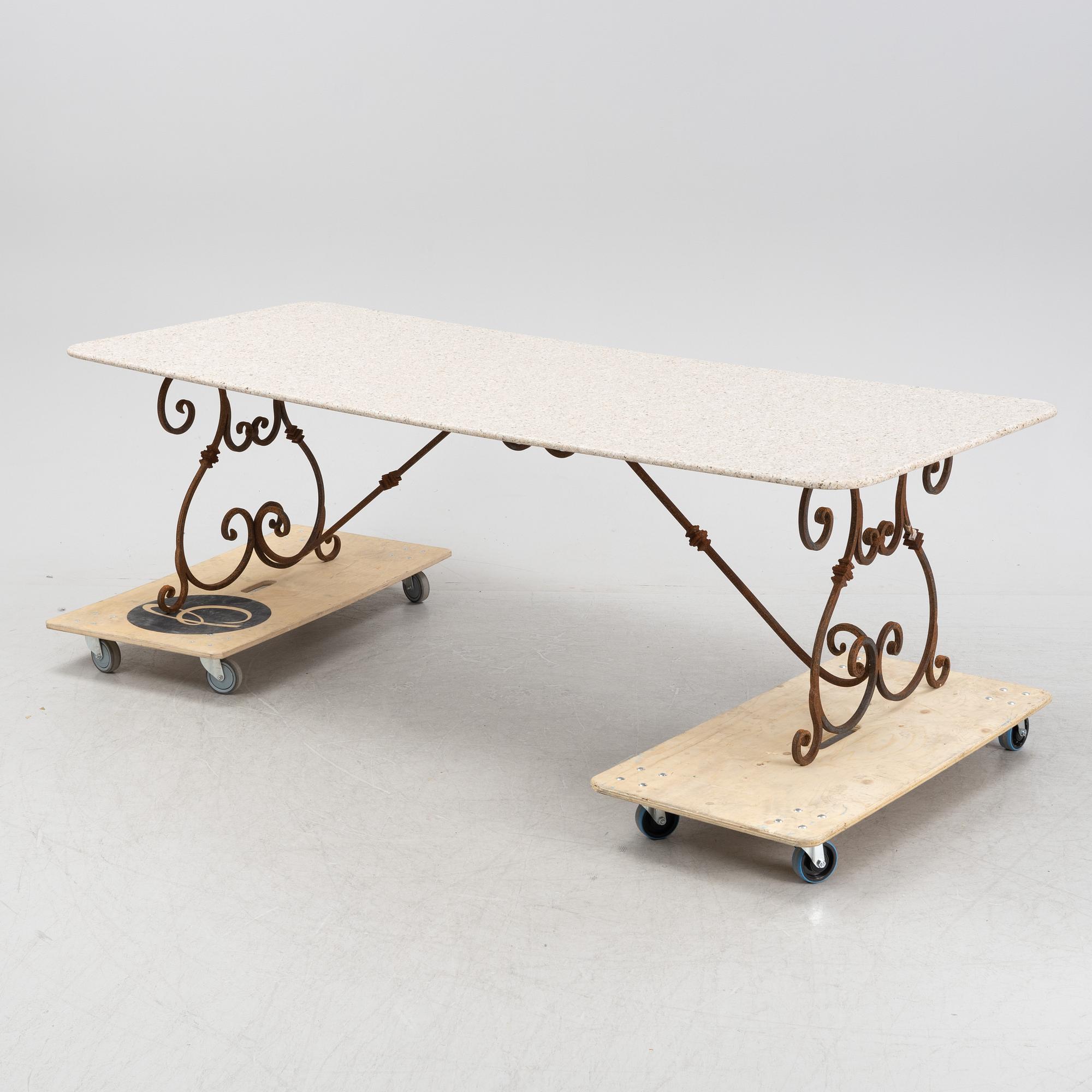A contemporary garden table with a stone top.
