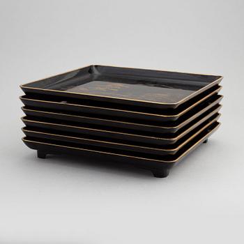 A set of six Japanese black lacquer trays, 20th century.