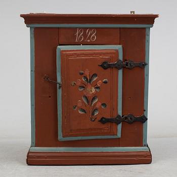 a painted cabinet dated 1828.