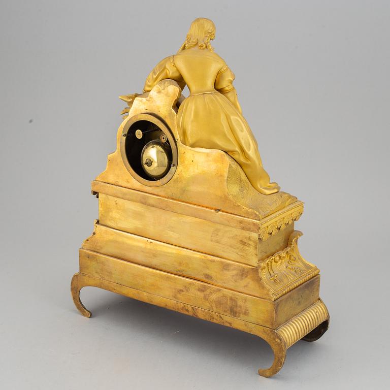 A French gilt bronze mantle clock, mid 19th century.