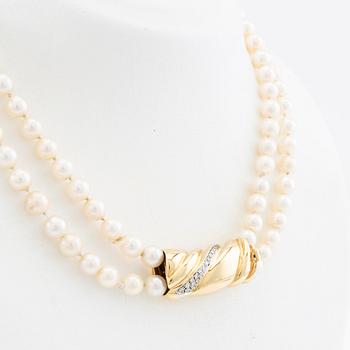 Necklace, two-stranded of cultured pearls with a clasp of 18K gold set with brilliant-cut diamonds, Damini Asolo Italy.