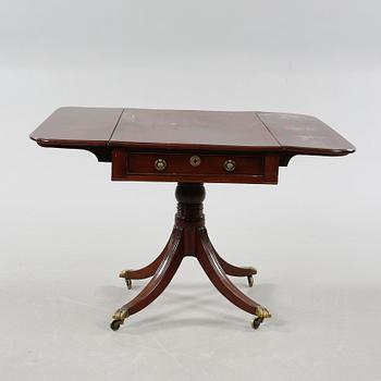 A drop-leaf table, English style, late 19th century.
