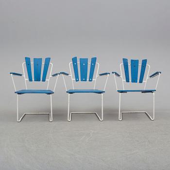 A mid 20th century garden table and three chairs.