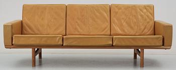 A Hans J Wegner oak and brown leather sofa,