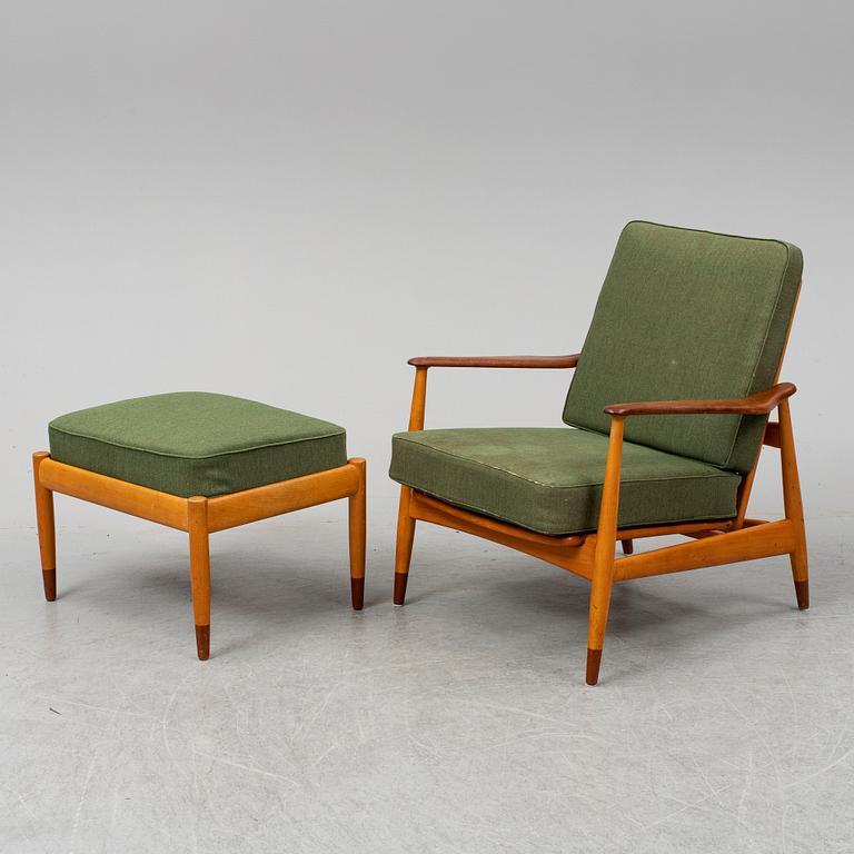 A 1950's beech and teak model FD 161 easy chair with stool by Arne Vodder for France & Son.