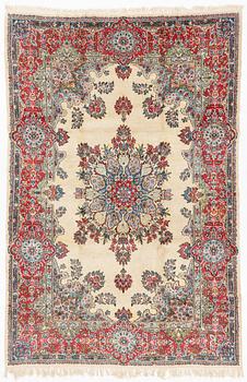 A carpet, old Kerman, approx. 314 x 210 cm.