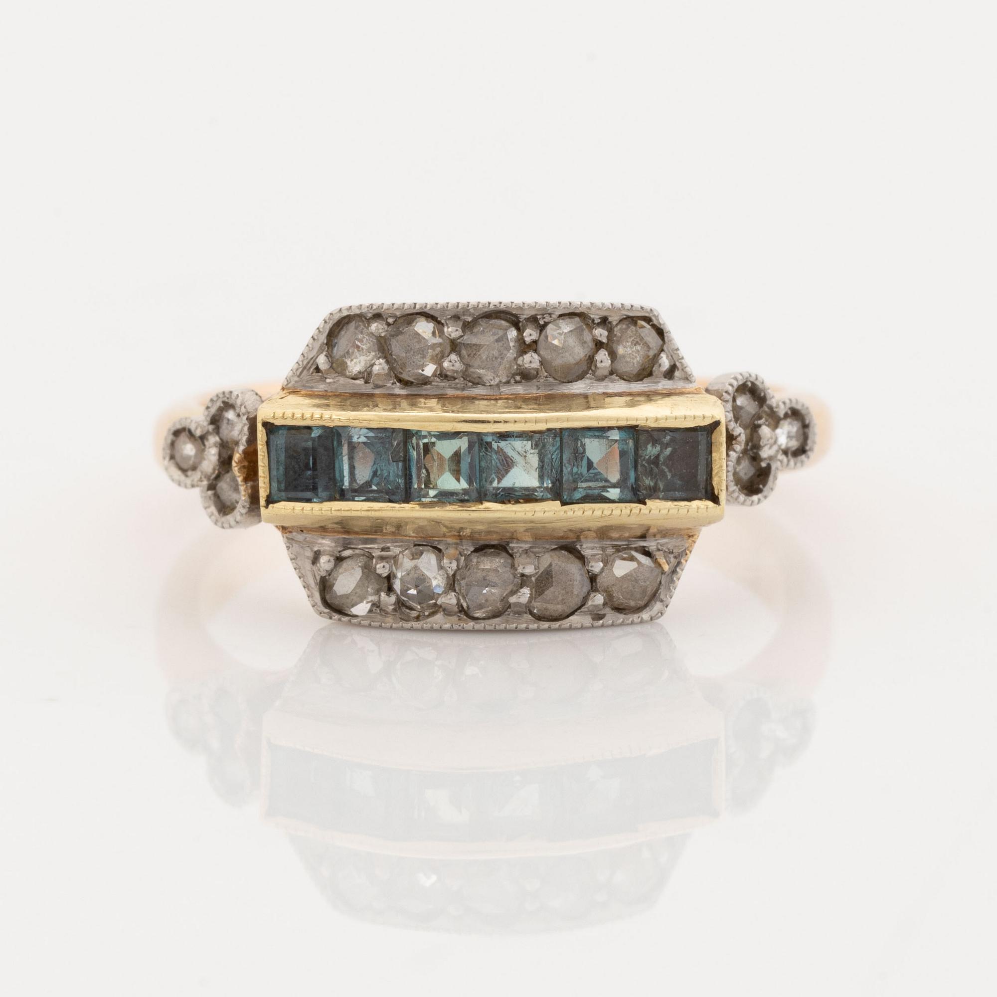A 14K gold and platinum ring set with green stones and rose-cut diamonds.
