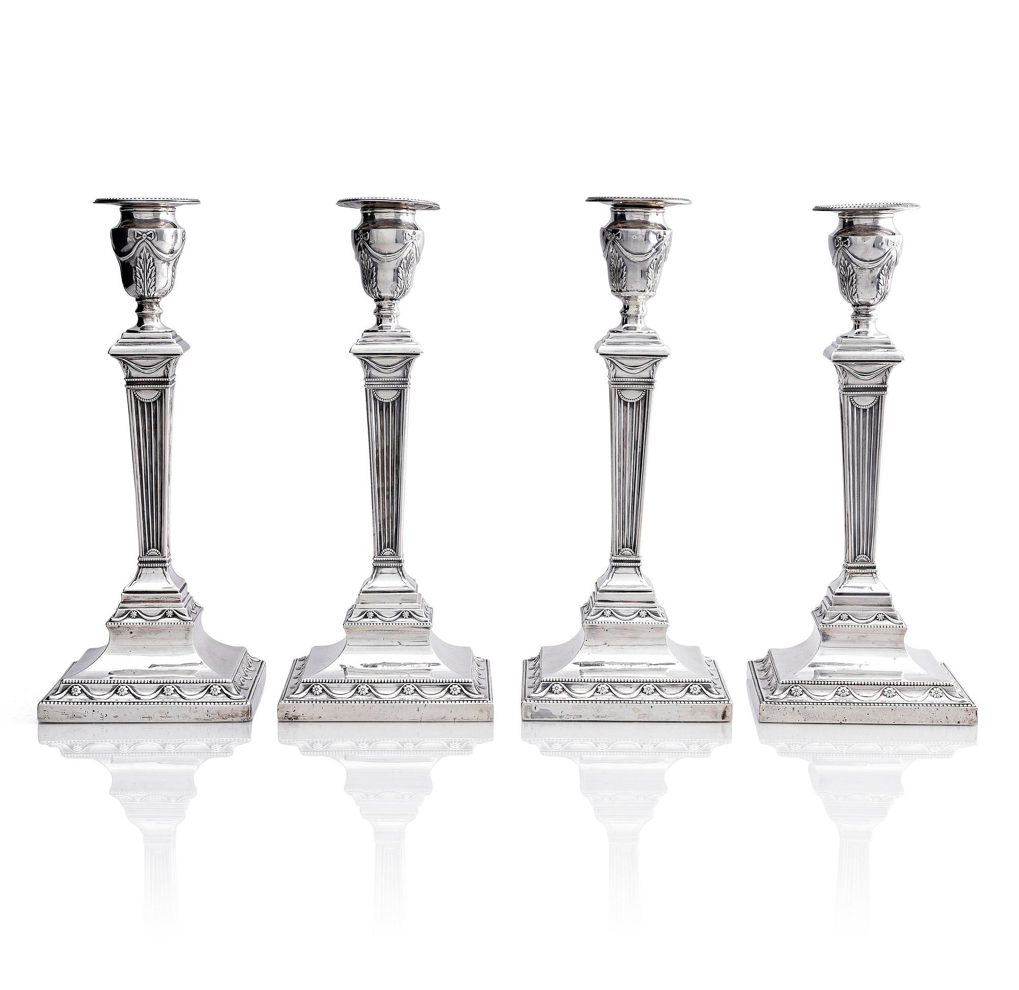 Four early 20th century silver candlesticks, marks of Hawksworth, Eyre & Co Ltd, Sheffield, England 1904-1906.